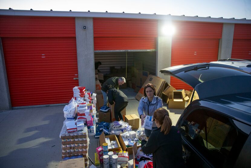 Rebecca Dominguez (center) hands medial supplies to Zeanly Gomez as they pack boxes at a...