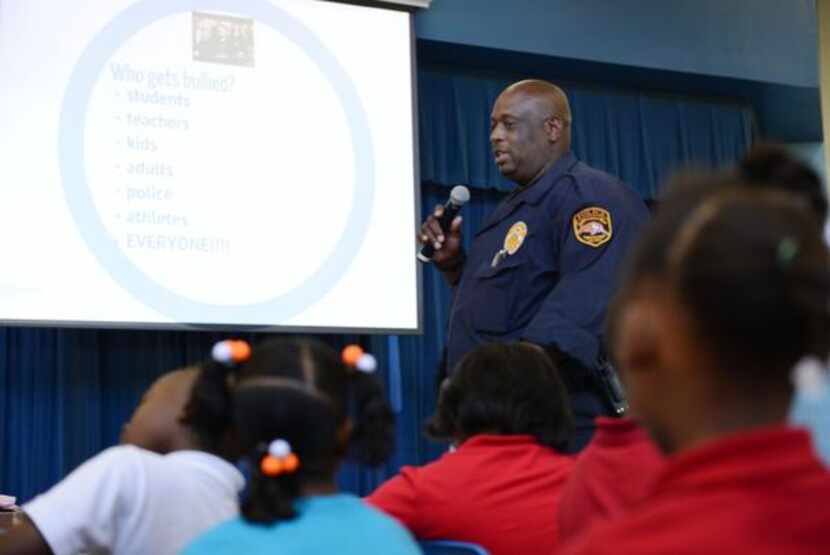
Lancaster ISD police officer Raymond Dyson speaks to students at Rolling Hills Elementary...