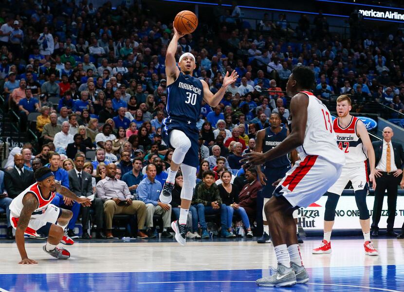 Dallas Mavericks guard Seth Curry (30) puts up a shot during the second quarter of a...