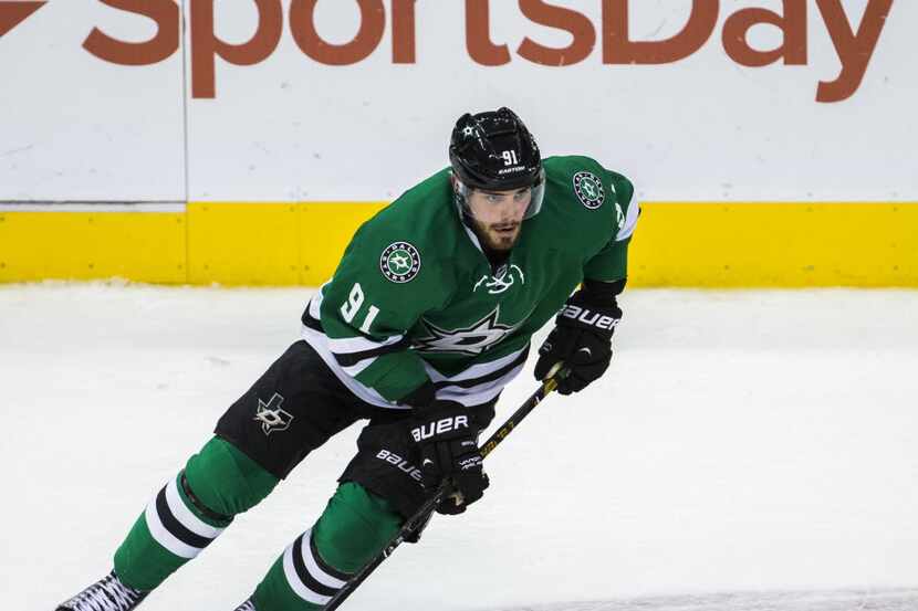 Dallas Stars center Tyler Seguin (91) skates with the puck during the third period of their...