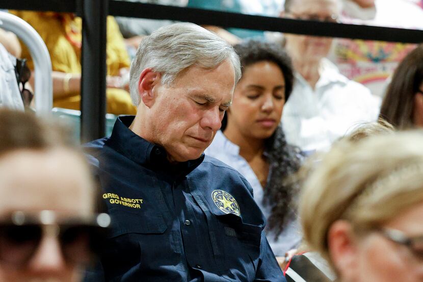 Gov. Greg Abbott prays during a vigil for victims of the Robb Elementary School shooting at...