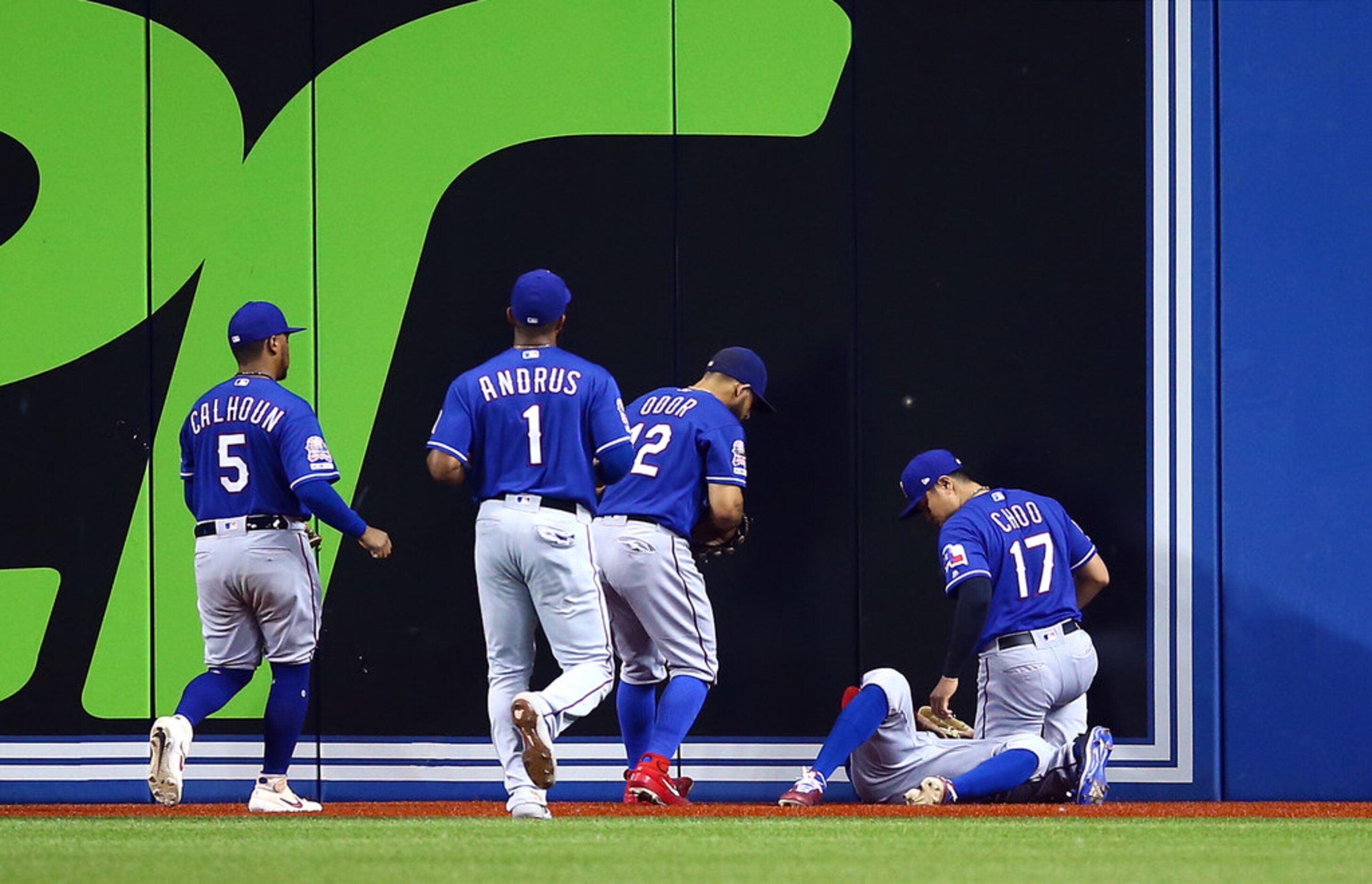 TORONTO, ON - AUGUST 13:  Delino DeShields #3 of the Texas Rangers is tended too by...