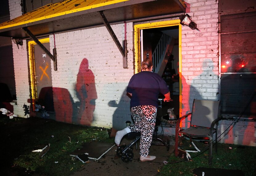 Minerva Rios looks into her apartment after the roof caved in at The Mirage Apartments on...