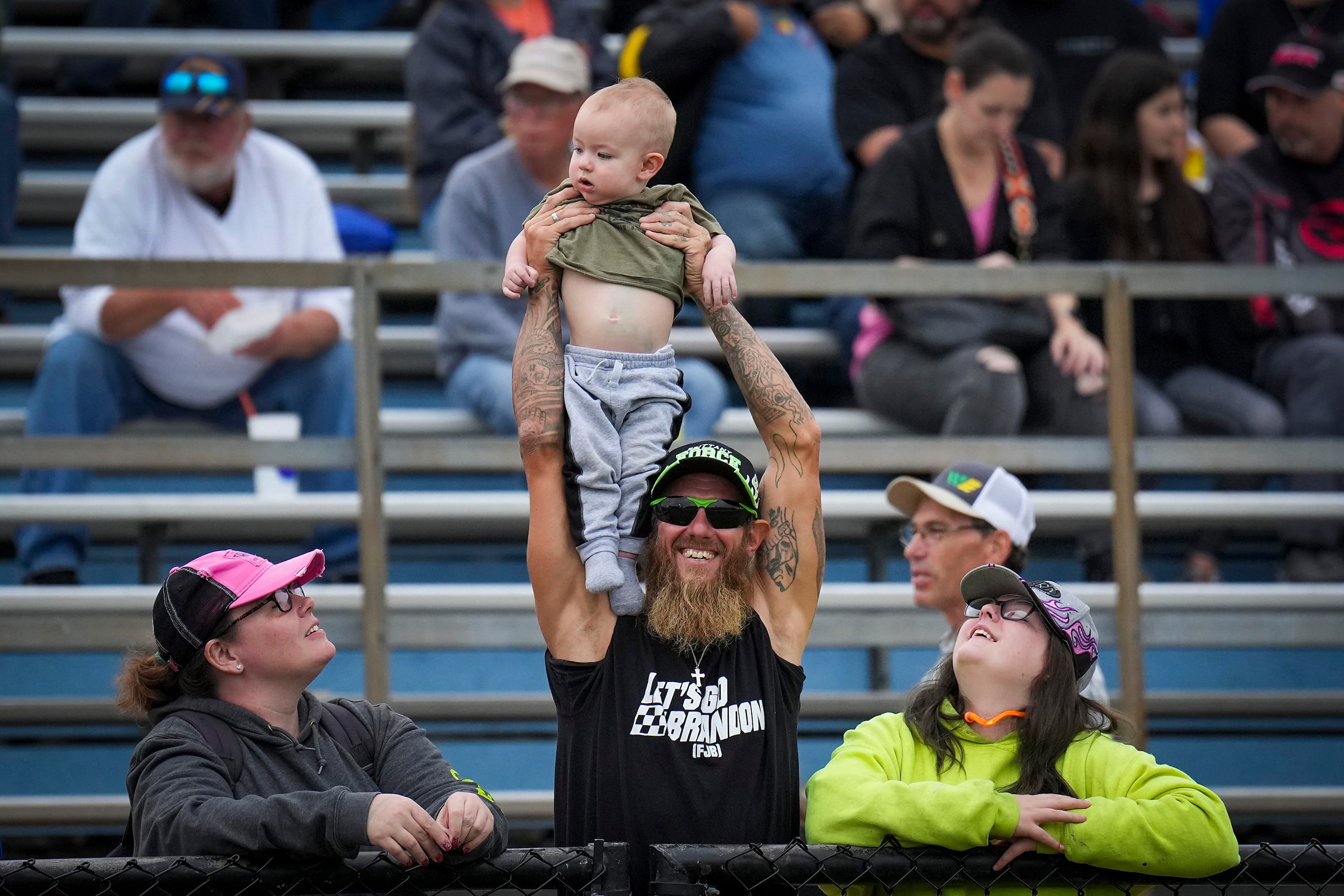 Fans cheer between races at the Texas NHRA FallNationals auto races at Texas Motorplex in...