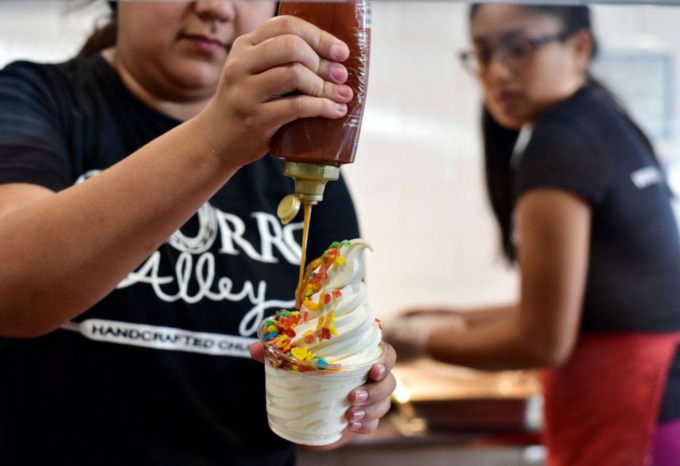 Vanessa Zapata prepares an Alley 3 dessert with Fruity Pebbles cereal and caramel.