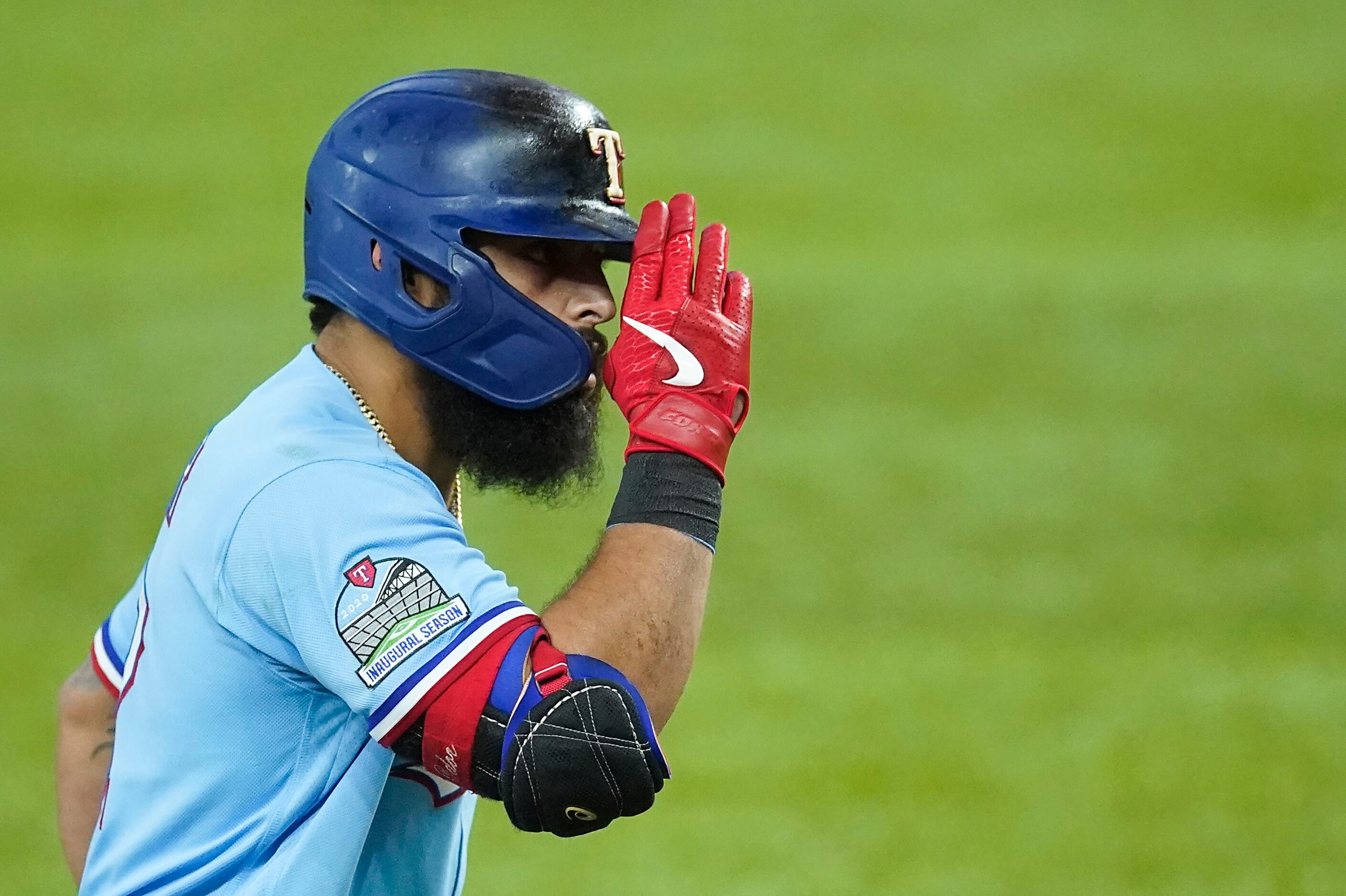 Texas Rangers second baseman Rougned Odor salutes third base coach Tony Beasley as he rounds...