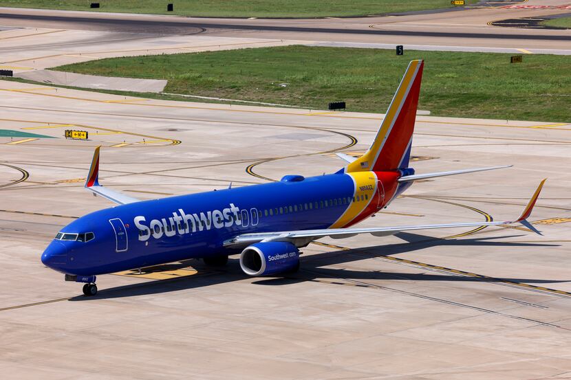 A Southwest Airlines flight taxis to a gate after landing at Dallas Love Field Airport in...