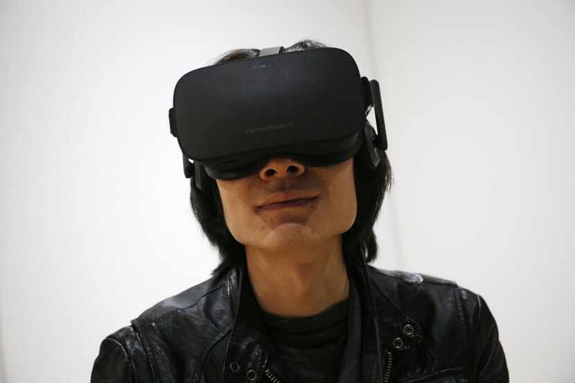 Peijun Guo wears the Oculus Rift VR headset at the Oculus booth at CES International,...