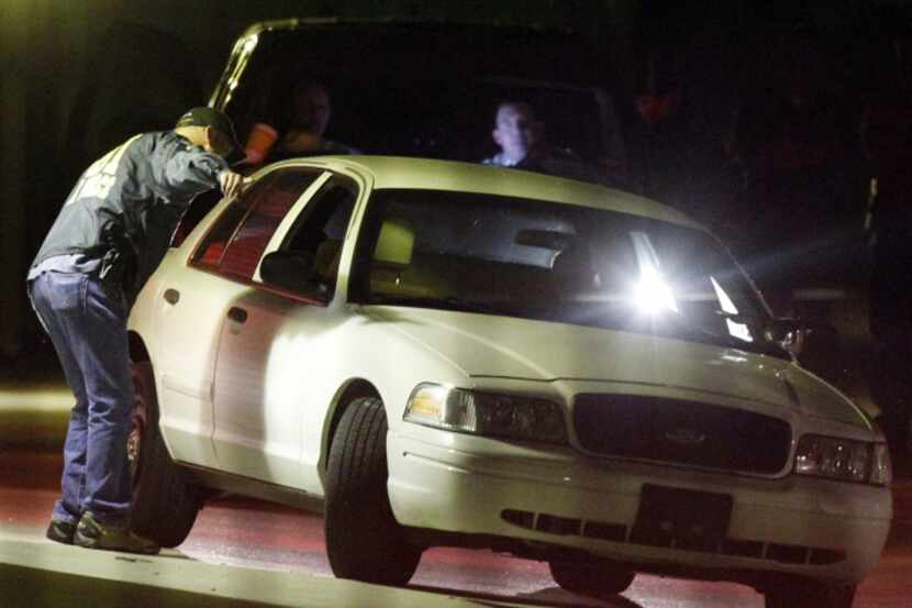  Texas Rangers and federal agents searched a storage unit, where a white Ford Crown Victoria...