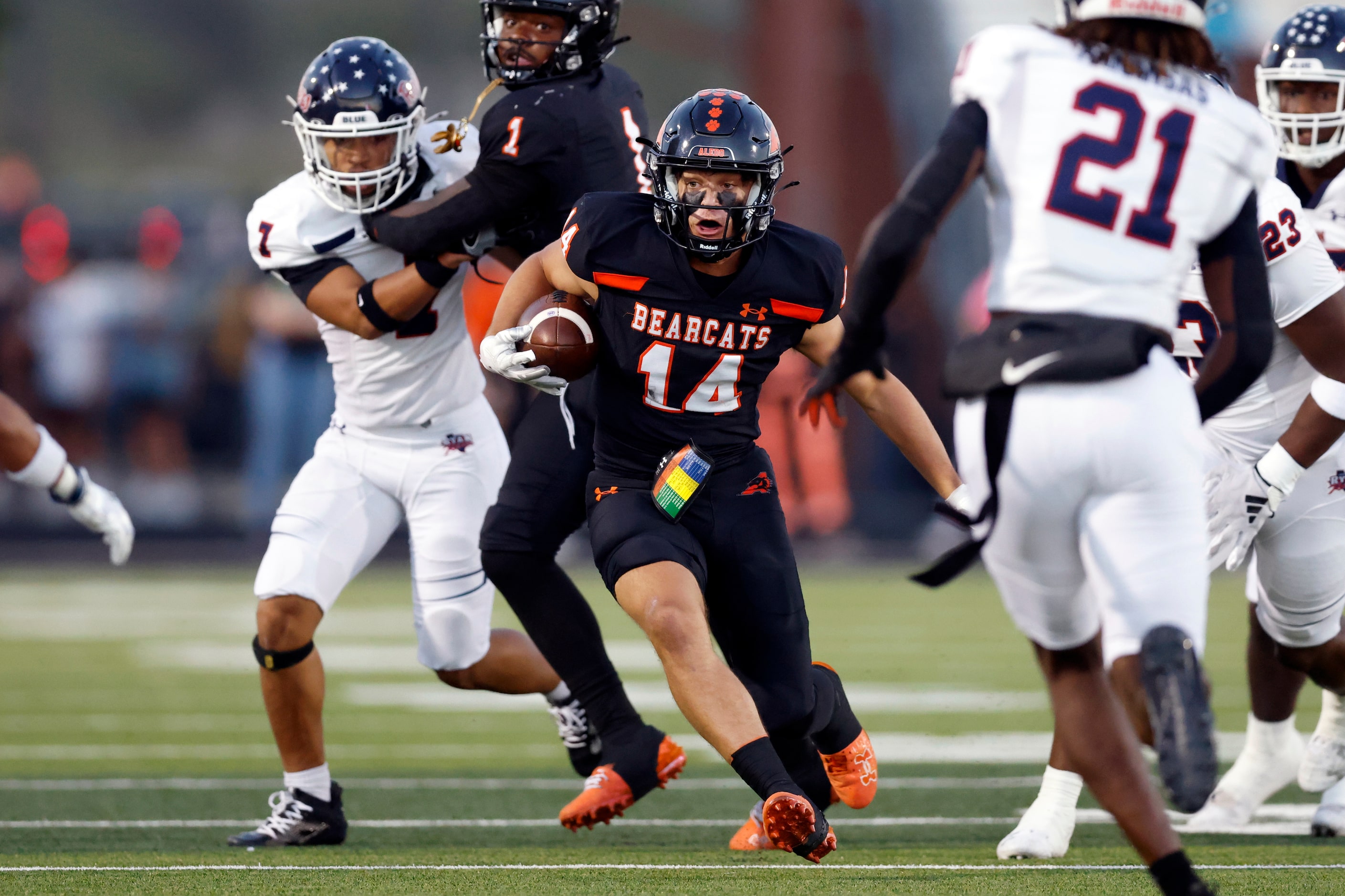 Aledo wide receiver Blake Burdine (14) runs the ball as the Denton Ryan defense tries to...