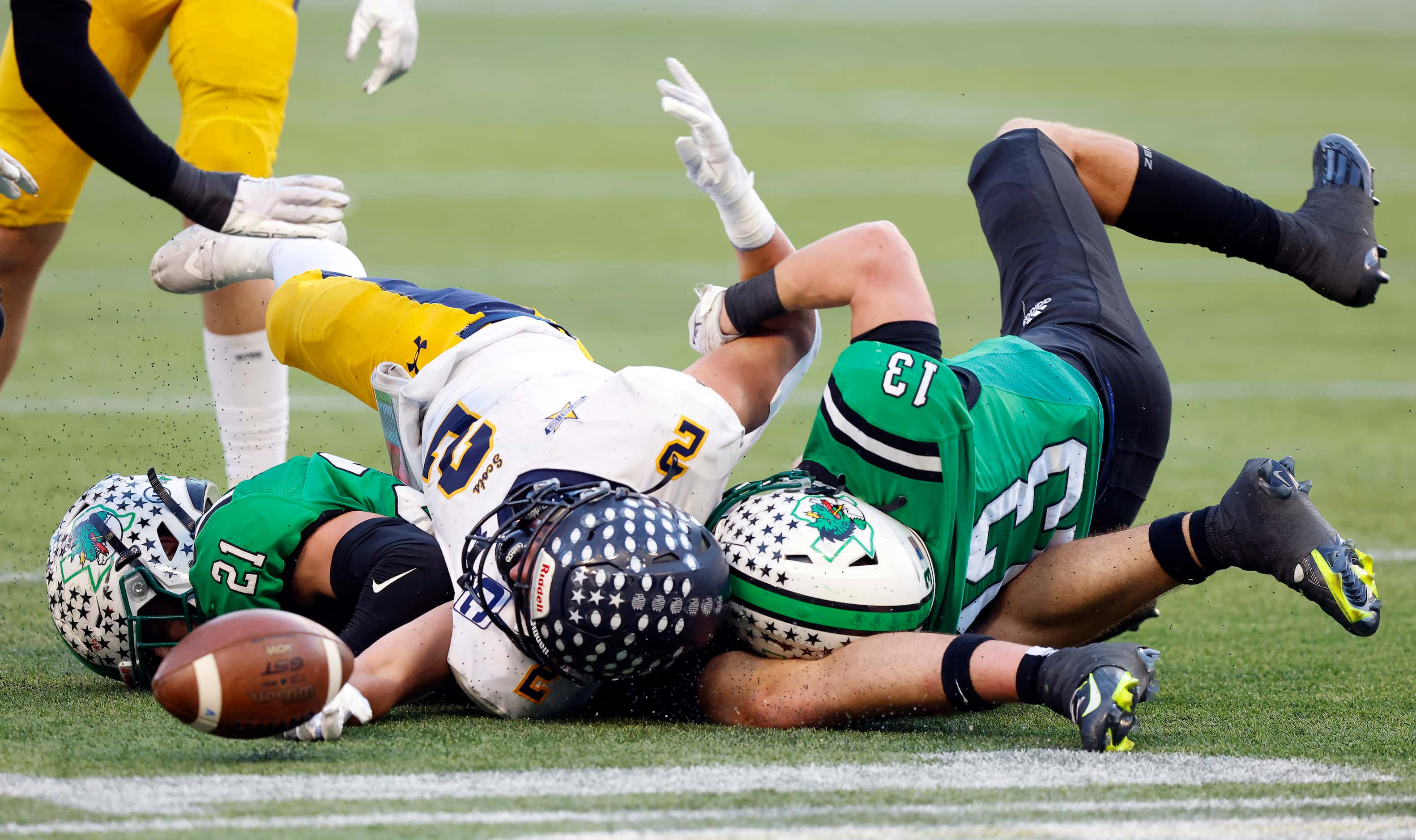Highland Park running back Wilson Axley (3) fumbles the ball as he sandwiched by Southlake...
