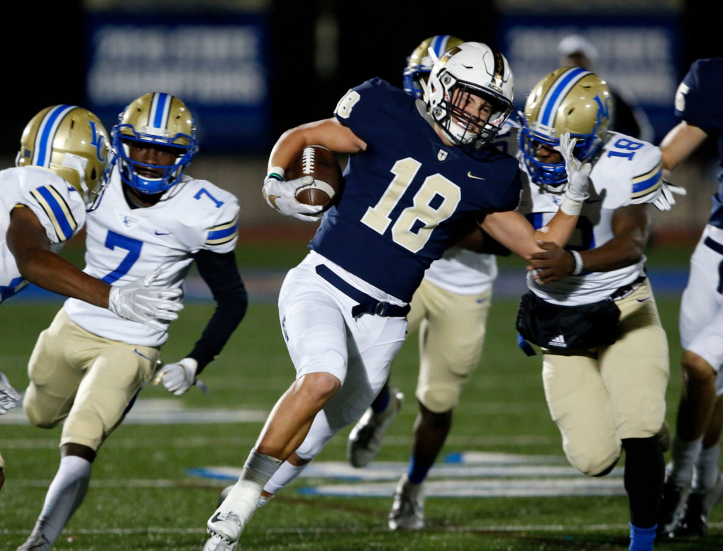 Jesuit's Robert Fitzgerald (18) tries to elude the Lakeview defenders during the first half...