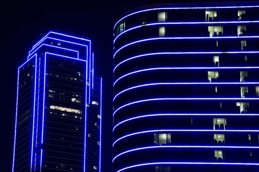 Bank of America and the Omni Dallas Hotel glow blue as the downtown Dallas skyline lights up...