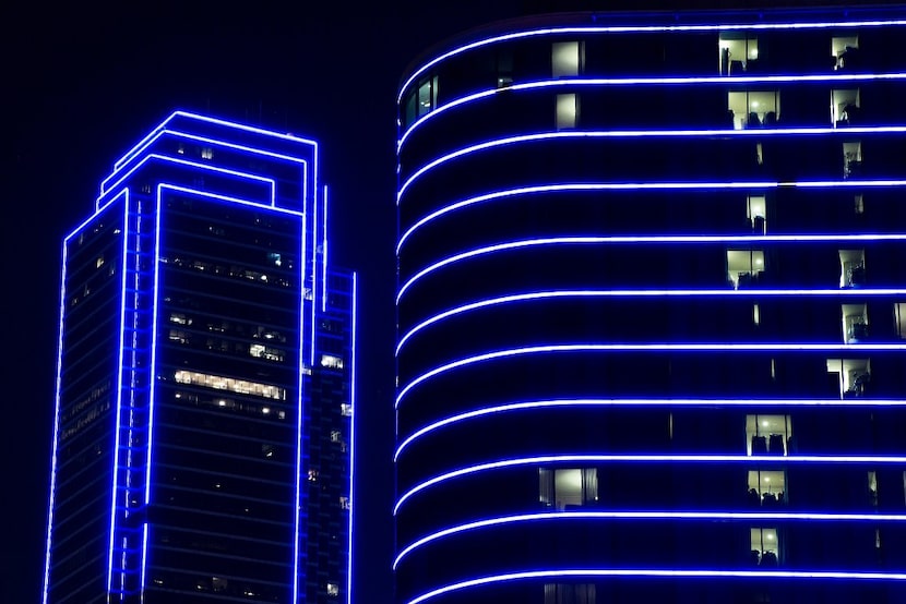 Bank of America and the Omni Dallas Hotel glow blue as the downtown Dallas skyline lights up...