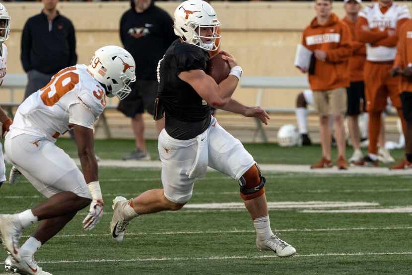 University of Texas quarterback Sam Ehlinger (11) is chased down by defensive back Montrell...