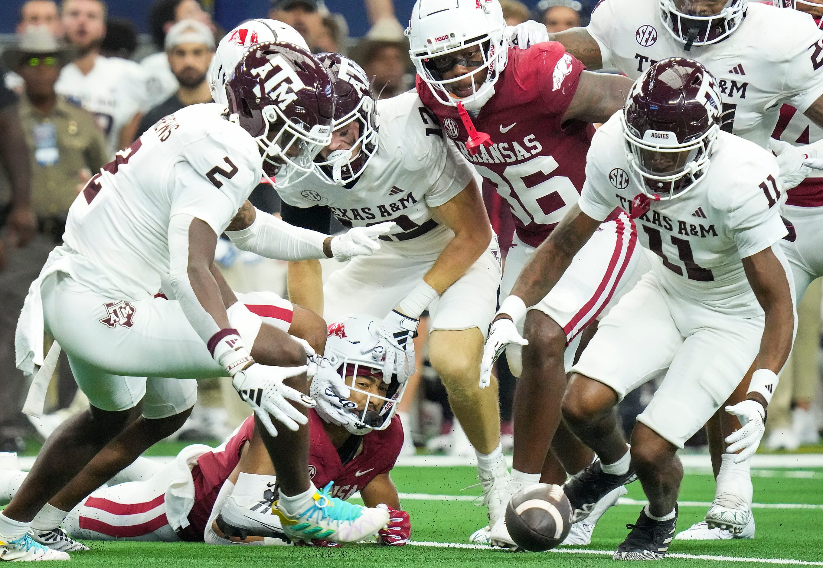 Texas A&M’s Jacoby Mathews (2) and Deuce Harmon (11) chase a fumble by Arkansas kick...