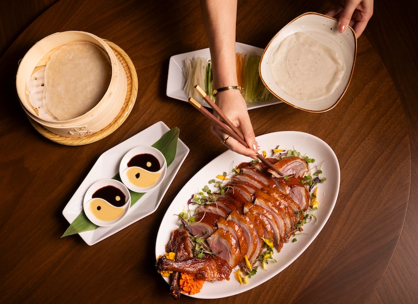 The MC Imperial Peking Duck is served with mandarin crêpes, cucumber, scallion, honeydew,...