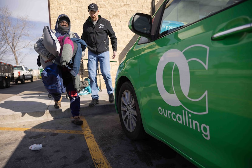 Brandon Wallace, street outreach manager for OurCalling, helps Jeff Bowen (left) as he...