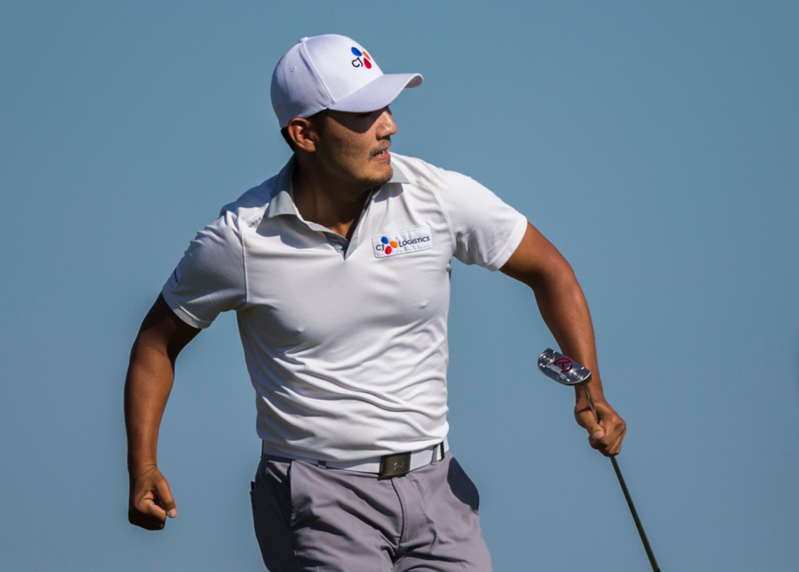 Sung Kang celebrates after sinking a putt on the 15th green during round 4 of the AT&T Byron...