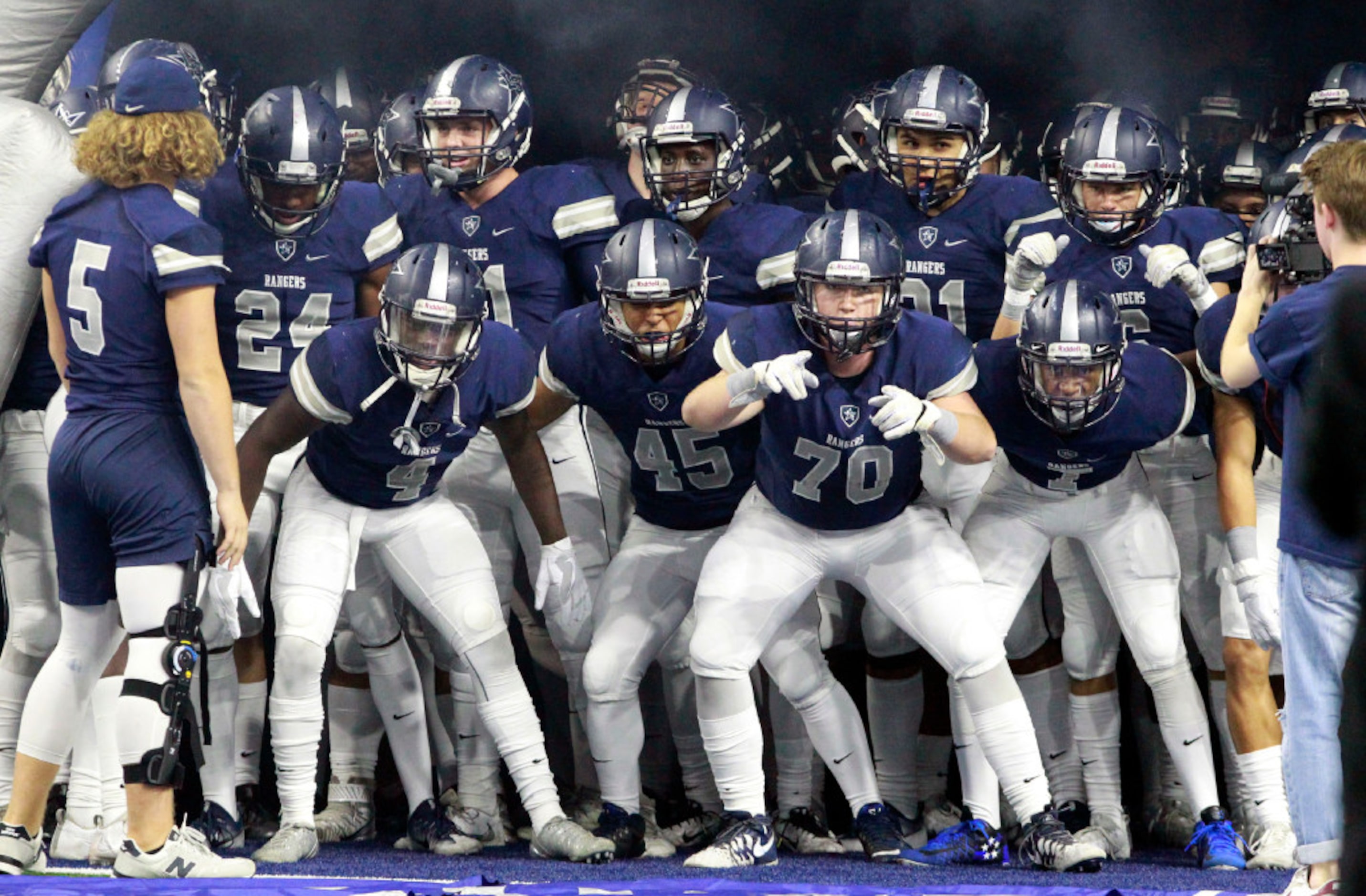 The Frisco Lone Star High team gets worked up before taking the field for the start of a...