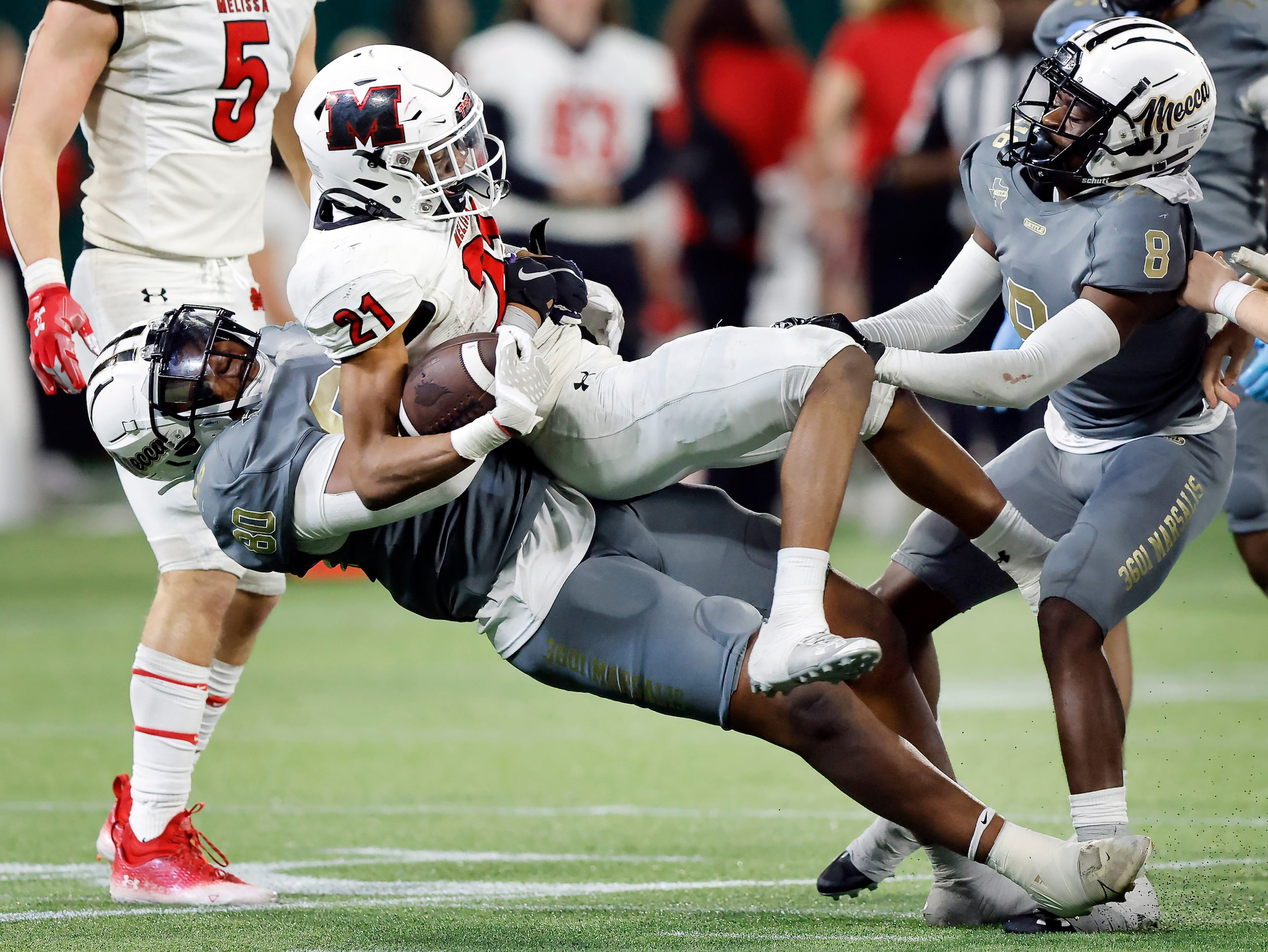 South Oak Cliff defensive lineman Keith Smith (80) throws Melissa running back Nathan...