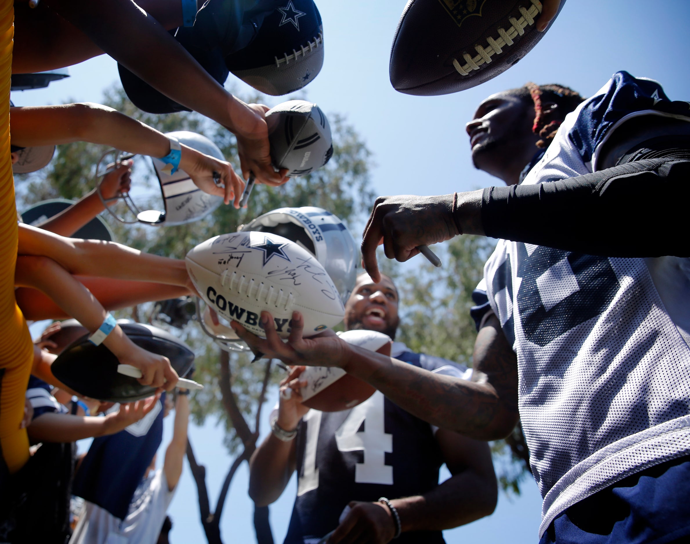 Dallas Cowboys linebacker Jabril Cox (14) and wide receiver CeeDee Lamb (88) signs mini...