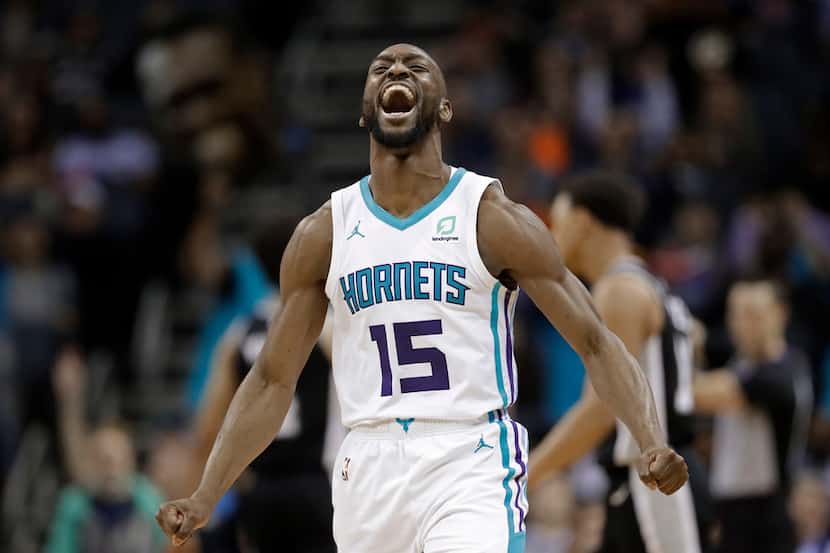 Charlotte Hornets' Kemba Walker (15) reacts after making a basket against the San Antonio...