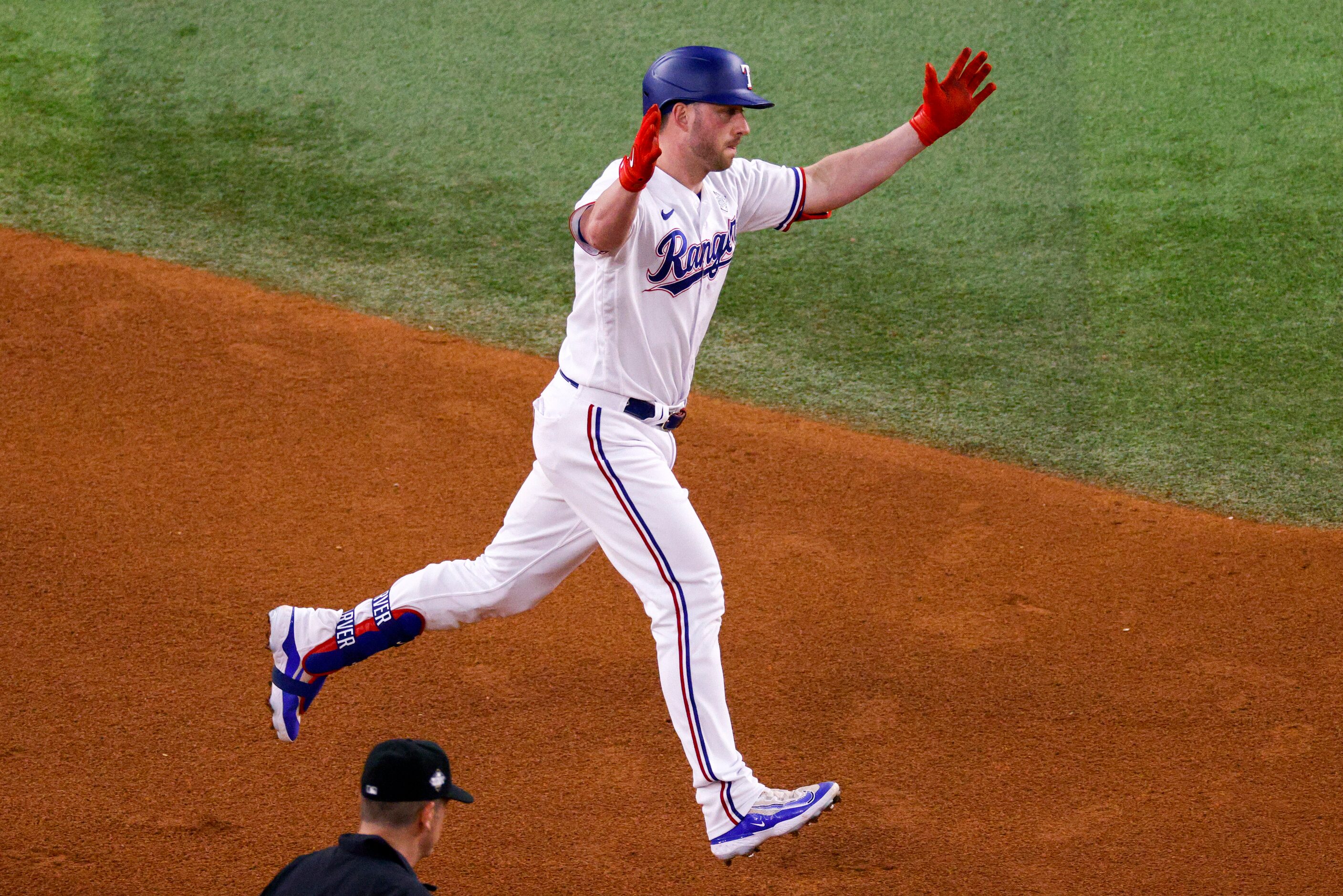 Texas Rangers catcher Mitch Garver (18) claps his hands after hitting a solo home run during...