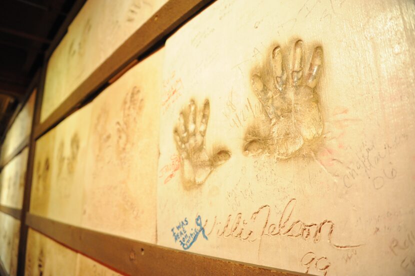 Celebrity artists, such as Willie Nelson, are invited to press their hands in cement and...