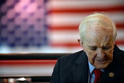 Congressman Sam Johnson lowers his head during a prayer after being honored on National...