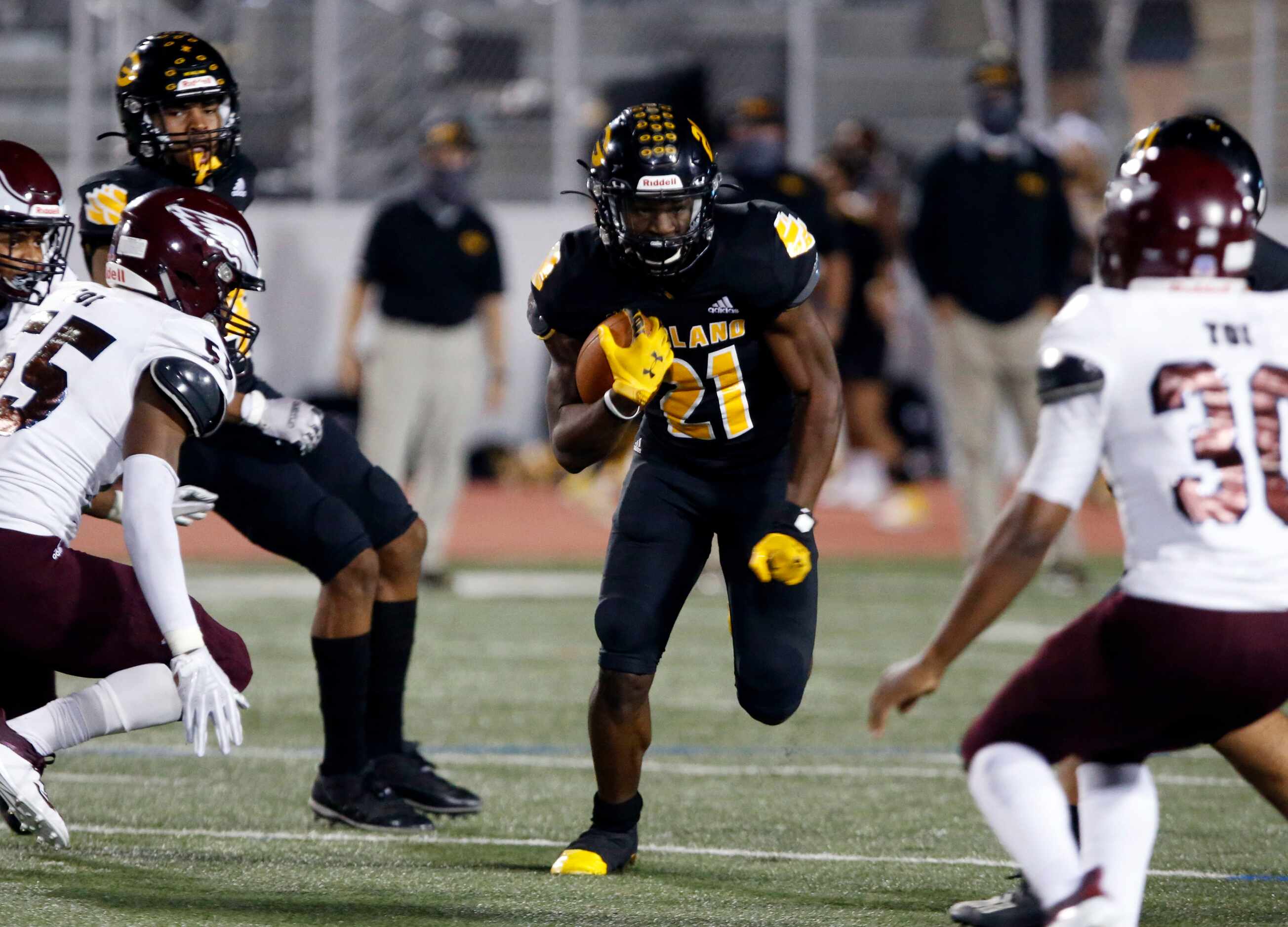 Garland’s Jayshon Powers (21) finds a gap to run through during the first half of high...