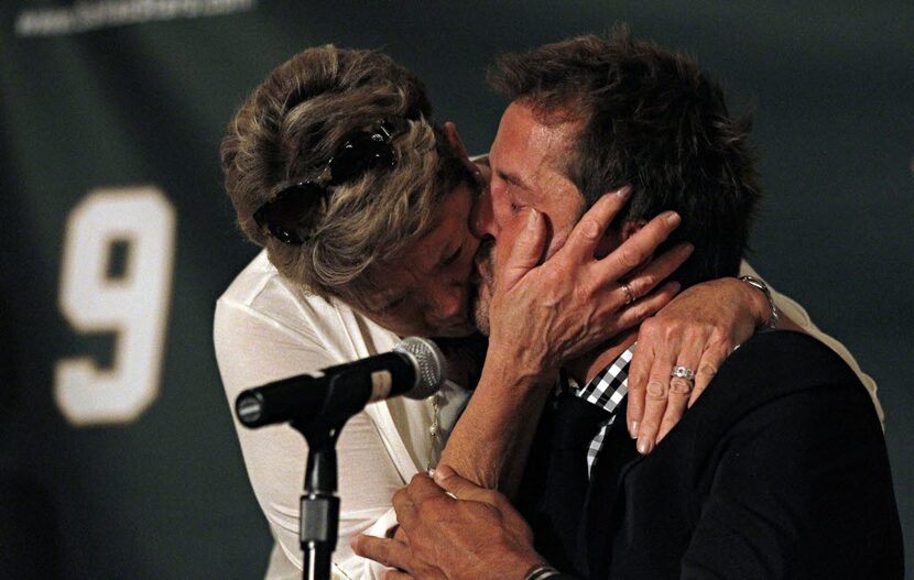 Former Dallas Stars player Mike Modano (right) kisses his mother, Karen Modano, after he...