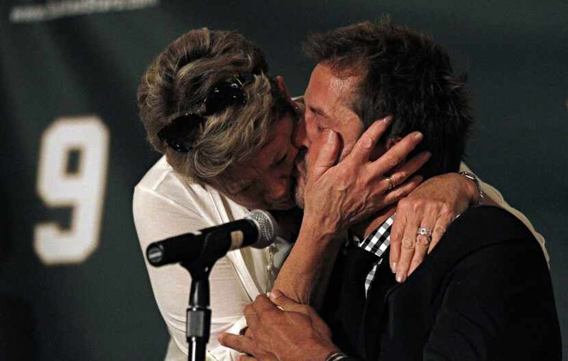 Former Dallas Stars player Mike Modano (right) kisses his mother, Karen Modano, after he...