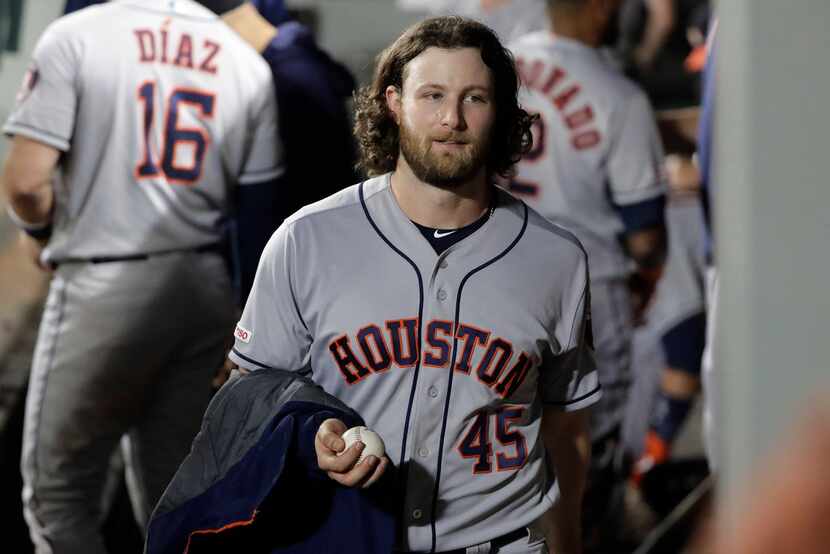 Houston Astros starting pitcher Gerrit Cole carries a game ball toward the clubhouse after...