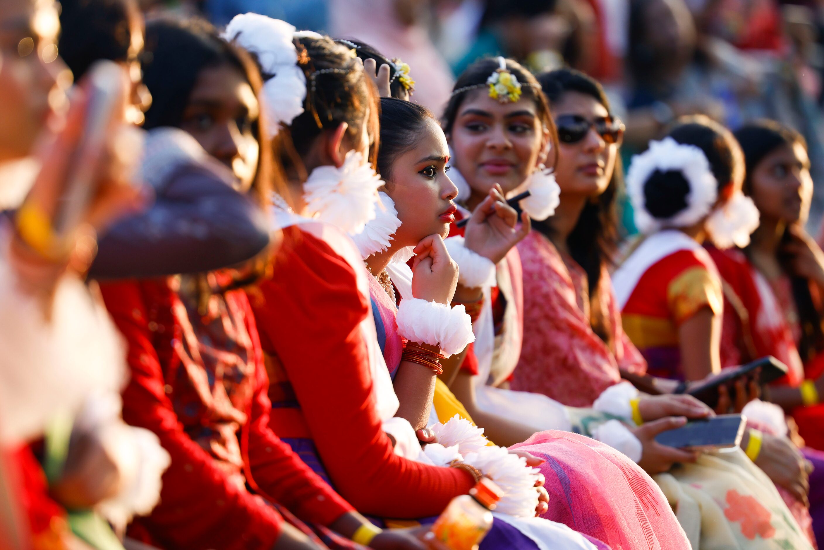 Young performers dressed with traditional Bangladeshi attire remain on the pavilion ahead of...