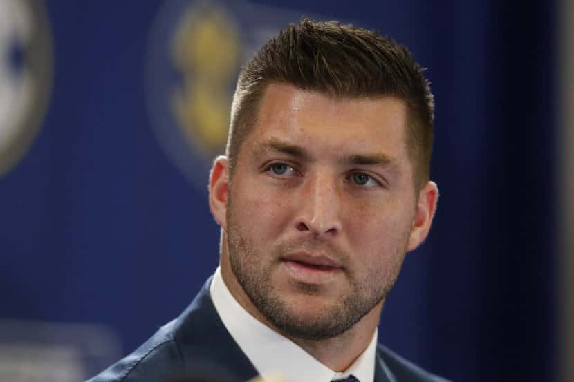 FILE - In this Dec. 5, 2014, file photo, Tim Tebow speaks during an SEC television broadcast...