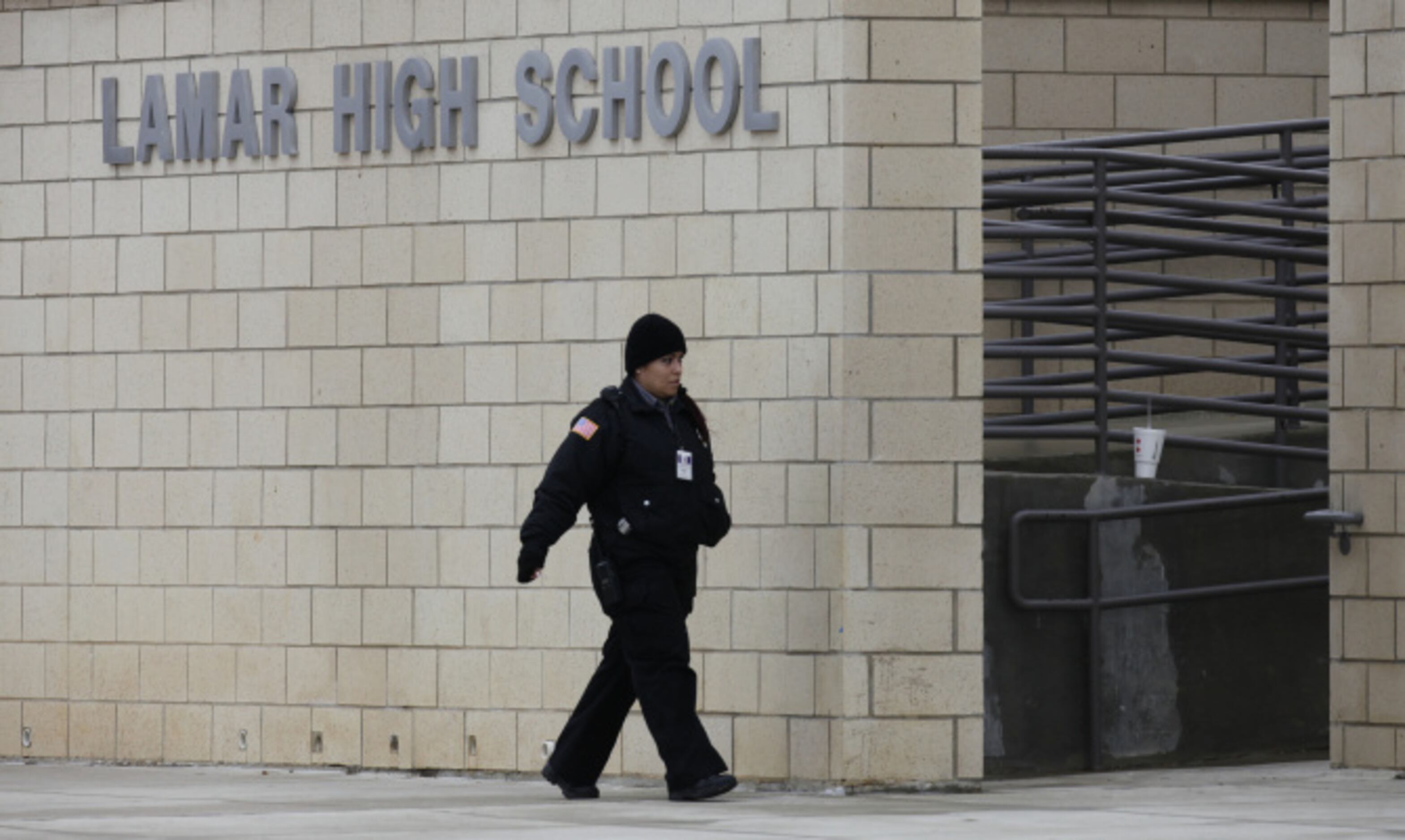 A police woman patrols the grounds during a lockdown at Arlington Lamar High School due to a...