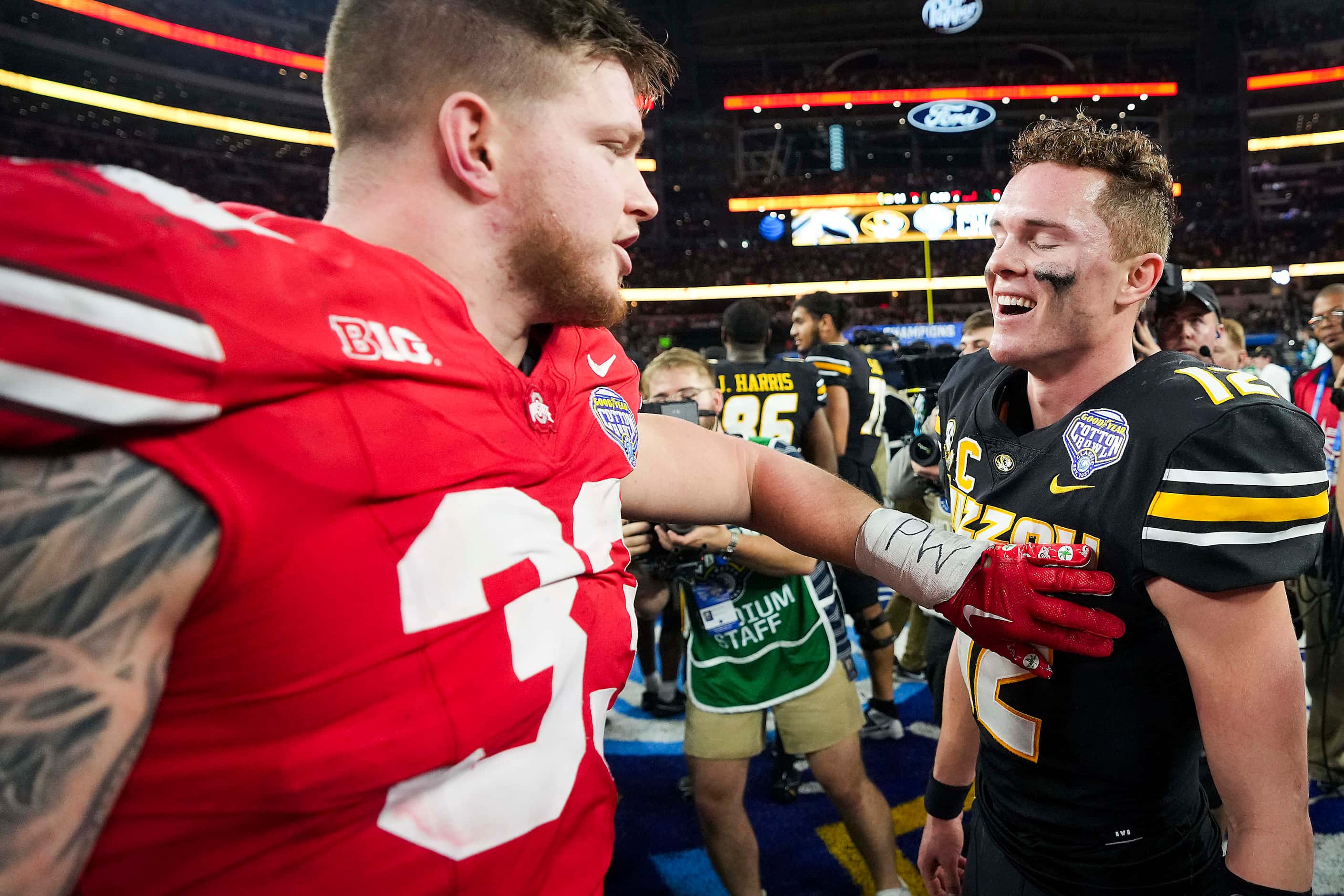 Missouri quarterback Brady Cook (12) is congratulated by Ohio State defensive end Jack...