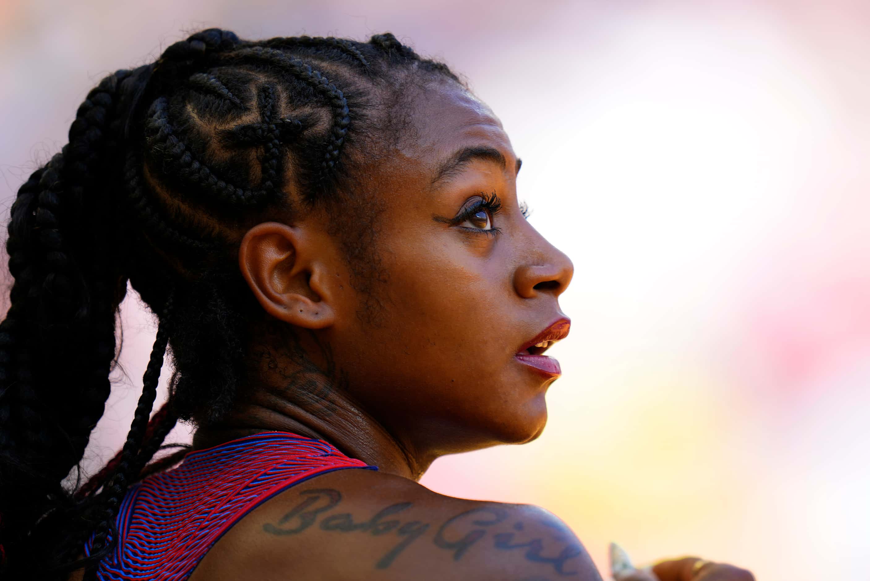 Sha'Carri Richardson, of the United States rests near the track after a Women's 200-meters...
