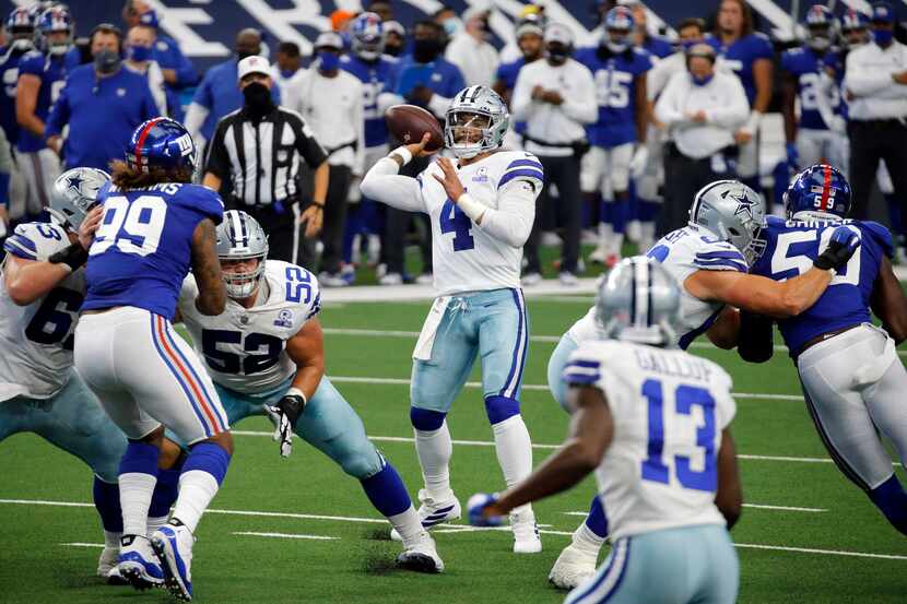 FILE - Cowboys quarterback Dak Prescott (4) throws a pass toward the end zone during the...