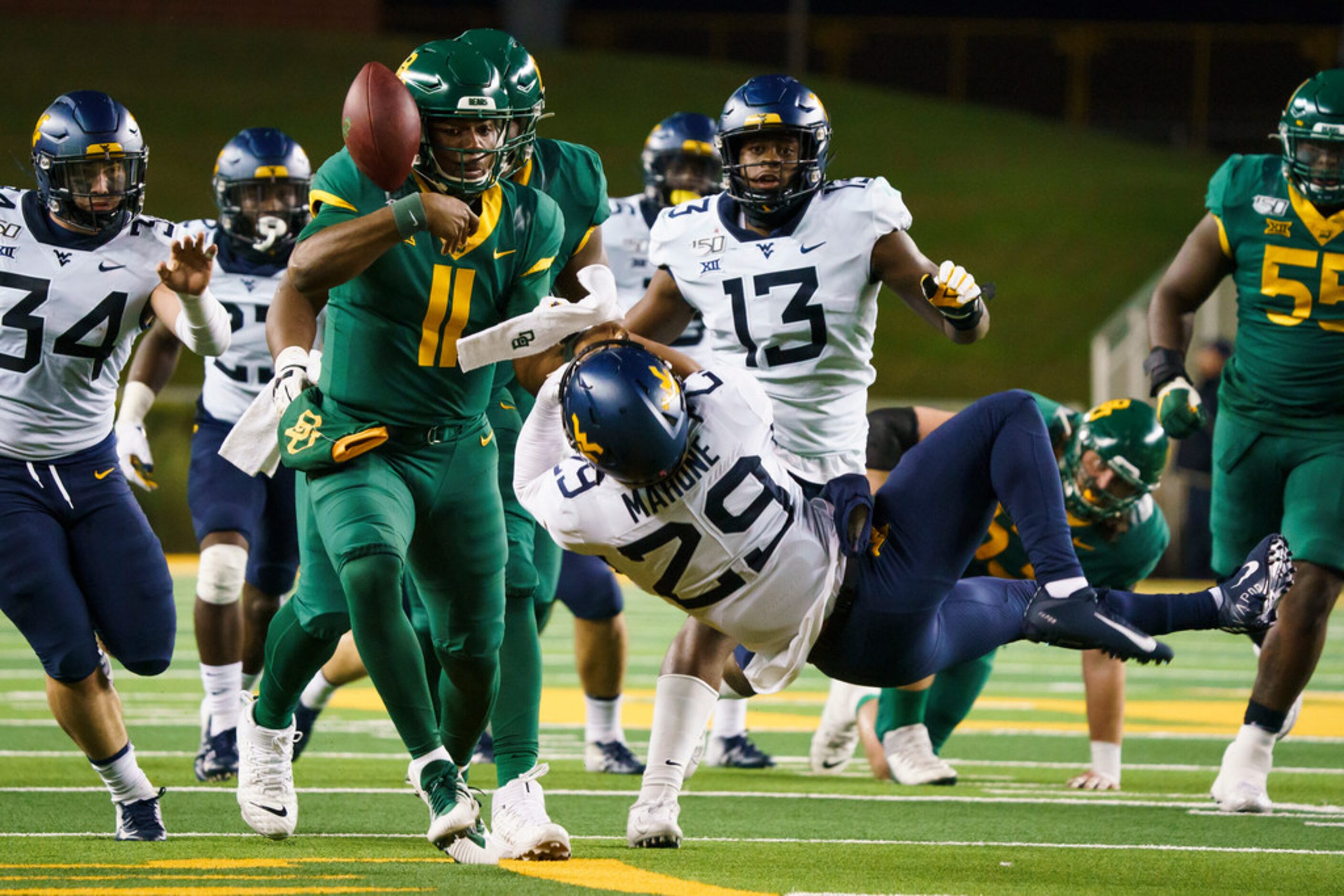 Baylor quarterback Gerry Bohanon (11) grabs his own fumble out of the air after hit from...