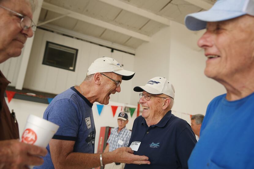 Don Gieseke (center left) and Dick Strohmeier, both retired Braniff pilots, shared a laugh...