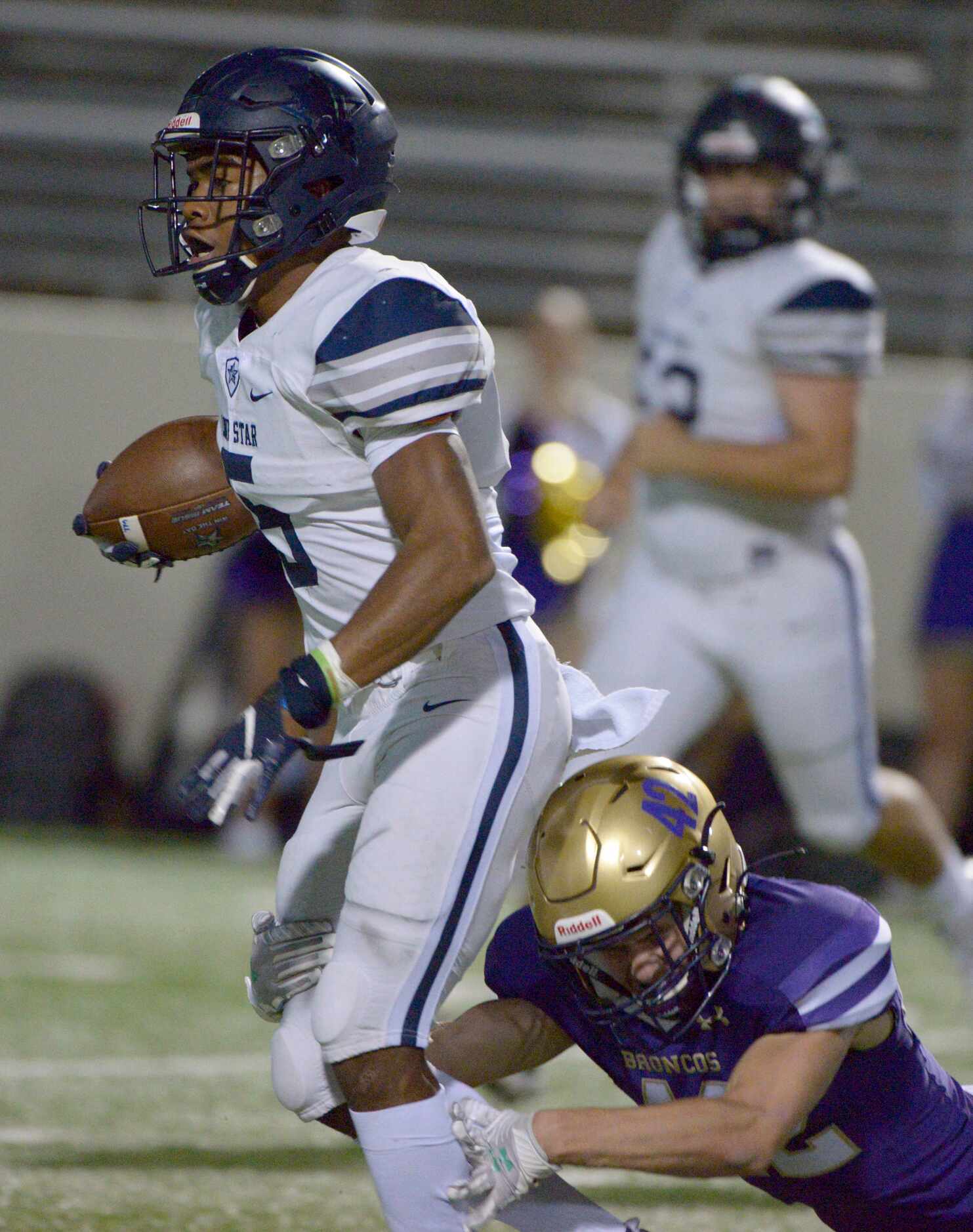 Lone Star’s Jaden Nixon (5) is tackled by Denton’s Amir Fera (42) in the first quarter of a...