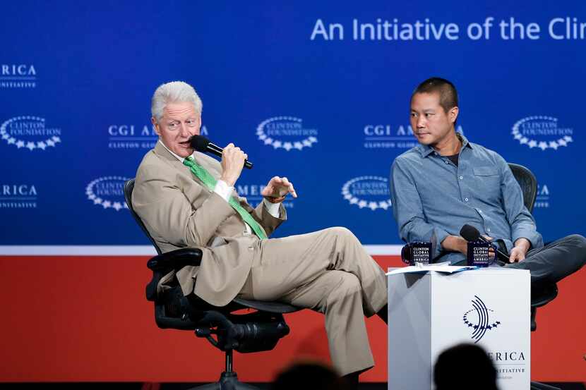 Former President Bill Clinton speaks with Zappos CEO Tony Hsieh, during a forum on the final...