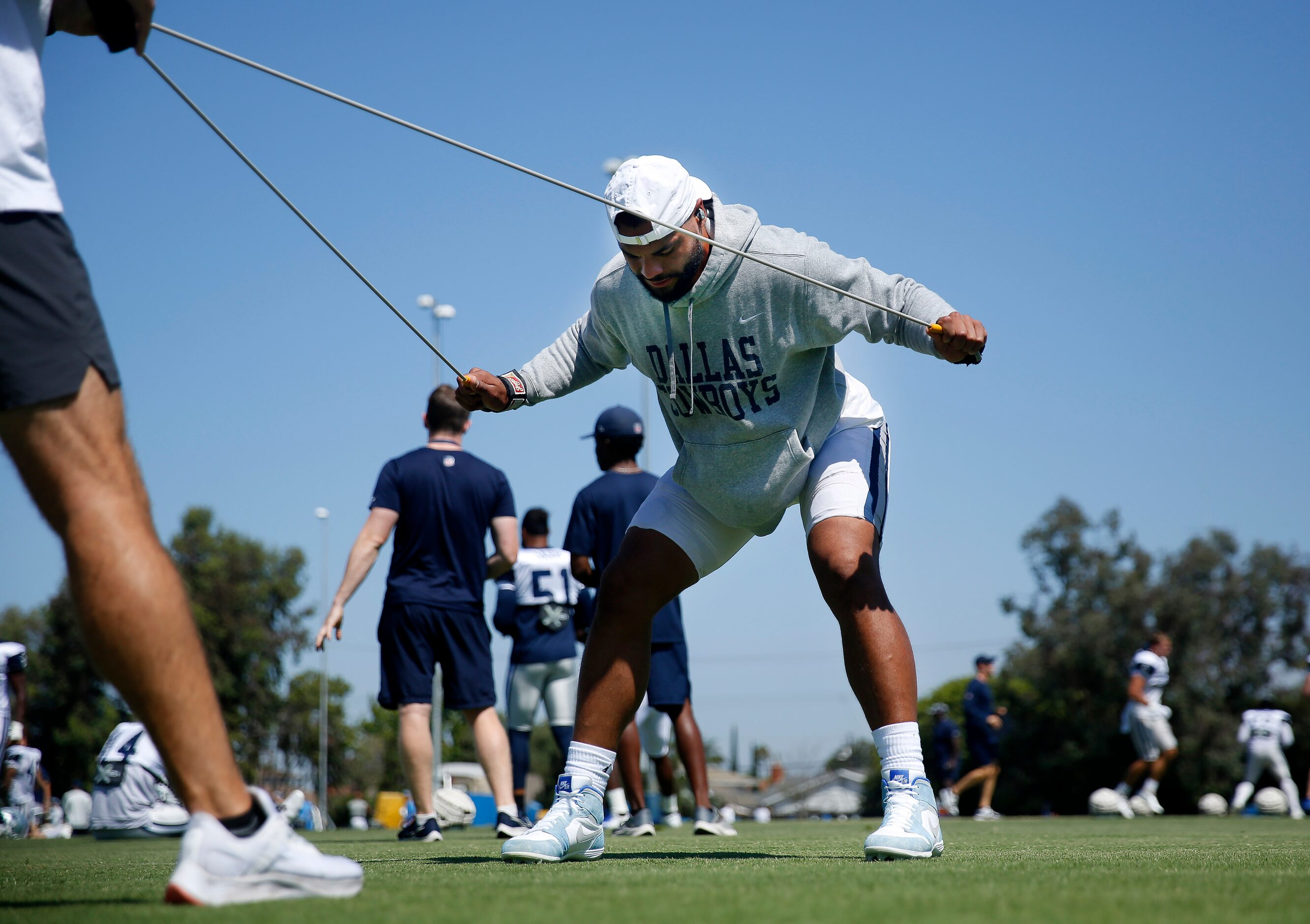 Dallas Cowboys quarterback Dak Prescott stretches before a joint practice with the Los...