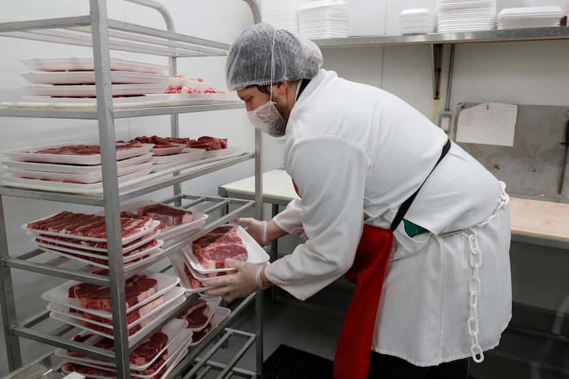Blake Lawrence, a meat cutter, prepares steaks for final packaging at the Joe V's Smart Shop...
