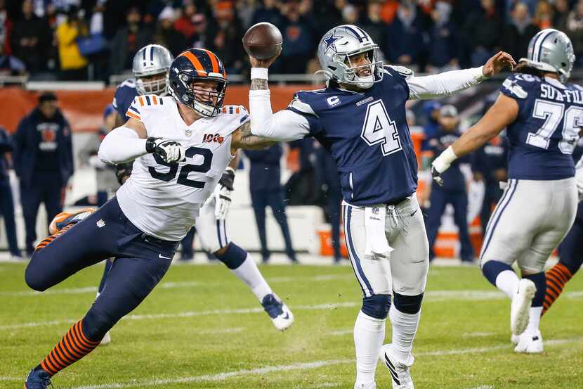 Dallas Cowboys quarterback Dak Prescott (4) fires off a pass before being brought down by...