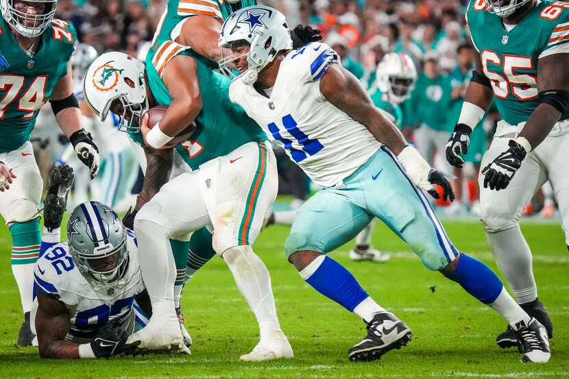 Miami Dolphins quarterback Tua Tagovailoa (1) is sacked by Dallas Cowboys defensive end...