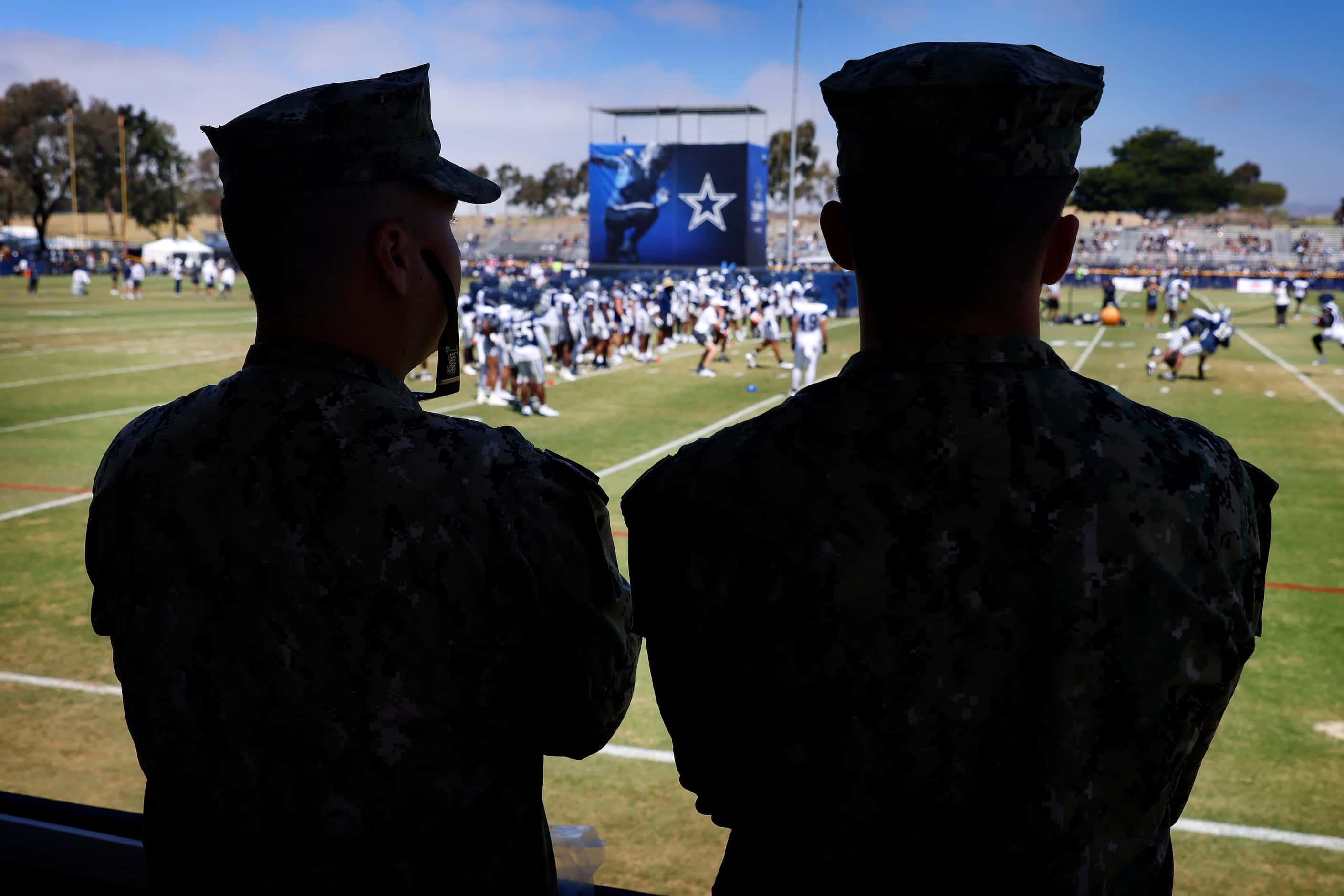 Naval Builder Third Classmen Caleb Alba (left) and Logan Bullock watch the Dallas Cowboys...