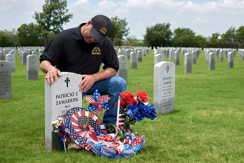 Enrique Zamarripa visits the grave of his son, Patrick Zamarripa, one of the five police...